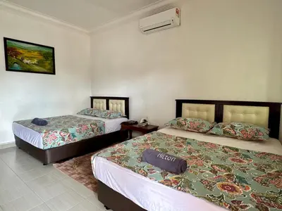 a hotel room with two beds and a sign on it at Villa Desa Permai in Sungai Besar