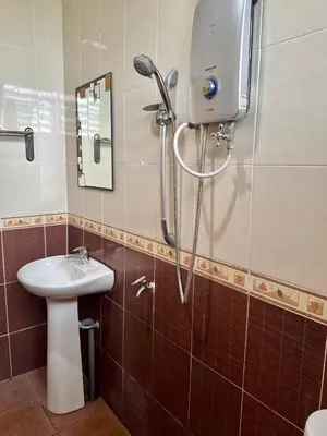 a bathroom with a shower and a sink at Villa Desa Permai in Sungai Besar