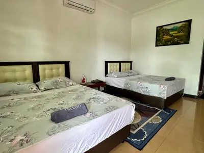 two beds in a room with two beds sidx sidx sidx at Villa Desa Permai in Sungai Besar