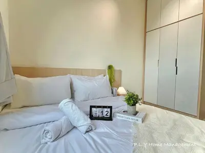 a bedroom with a bed with a clock on it at Kampung Paloh Residence Ipoh Town in Ipoh