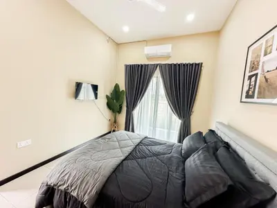 a bedroom with a bed and a window at The Canal Villa in Sungai Besar