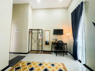 a room with a desk and a chair and a table at The Canal Villa in Sungai Besar