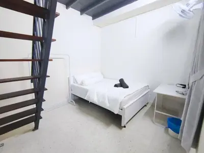 a bedroom with a white bed and a ladder at Ipoh Tambun Field - Landed House 9px - 3R2B in Ipoh