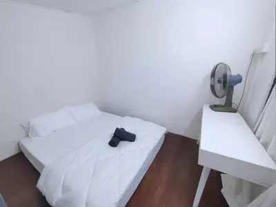a white bed with a black tie sitting on it at Ipoh Tambun Field - Landed House 9px - 3R2B in Ipoh