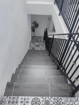 a stairway with a potted plant in the middle at Private Roomstay Shared Home Near KTM Batu Gajah in Batu Gajah