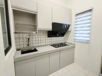 a white kitchen with a sink and a stove at Private Roomstay Shared Home Near KTM Batu Gajah in Batu Gajah
