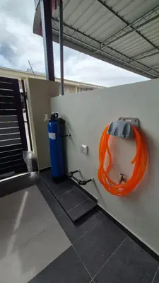 an orange object on a wall next to a trash can at Hatasan Homestay Guess House