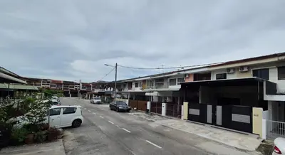 a street with cars parked on the side of a building at Hatasan Homestay Guess House