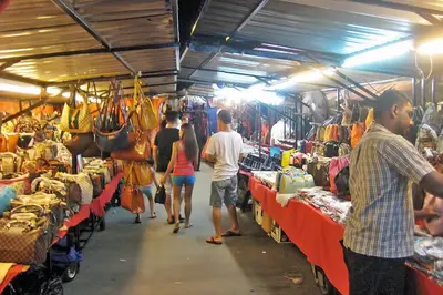 a group of people walking through a market at Batu Ferringhi Sri Sayang Resort in Batu Ferringhi
