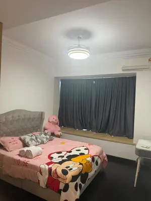 a bedroom with a bed with a cow blanket at R&F Seine Region in Gua Sai