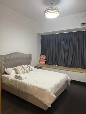 a bedroom with a large bed and a window at R&F Seine Region in Gua Sai