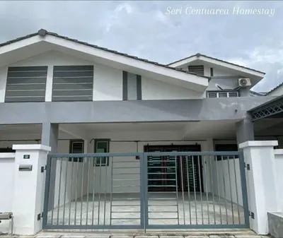 a house with a gate in front of it at Seri Centuarea Homestay, Seri Iskandar in Seri Iskandar