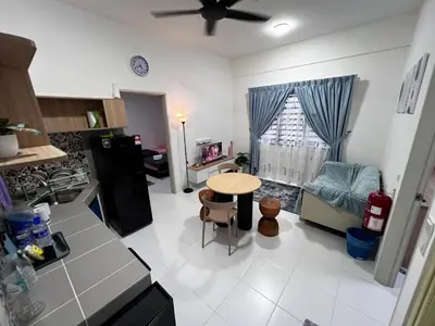 a kitchen and living room with a table in it at Homestay Kesidang in Seri Iskandar