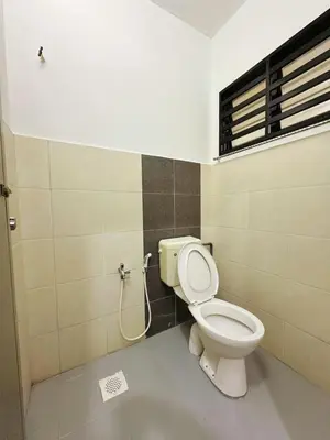 a bathroom with a toilet and a window at Ipoh Pengkalan Homestay in Ipoh