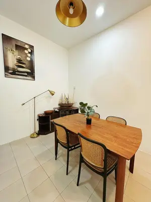 a dining room with a wooden table and chairs at Ipoh Pengkalan Homestay in Ipoh