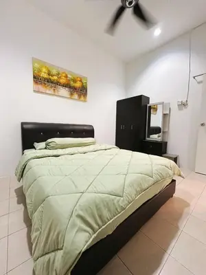 a bedroom with a bed and a painting on the wall at Ipoh Pengkalan Homestay in Ipoh