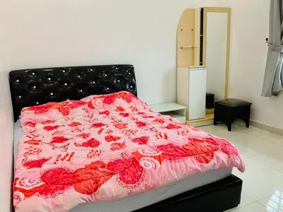 a bed with a red blanket with roses on it at Taiping Nest Homestay 3BR, 7Pax, WiFi, Private Parking, Comfy in Taiping