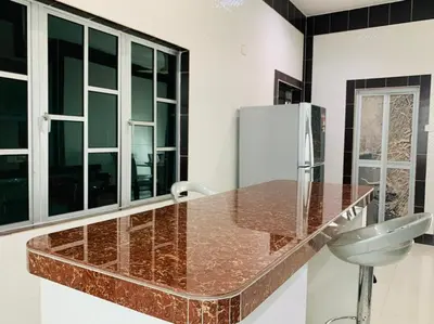 a kitchen with a counter with a sink and a refrigerator at Taiping Nest Homestay 3BR, 7Pax, WiFi, Private Parking, Comfy in Taiping