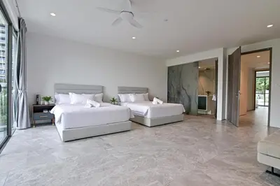 two beds in a large room with a couch at Modern Luxury Villa Hinai by Simple Sanctuary in George Town