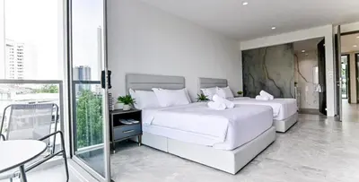 two white beds in a bedroom with a balcony at Modern Luxury Villa Hinai by Simple Sanctuary in George Town