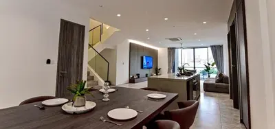 a dining room and living room with a table and chairs at Modern Luxury Villa Hinai by Simple Sanctuary in George Town