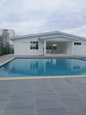 a house with a swimming pool in front of a building at HS Homestay Casa Klebang Ipoh in Chemor