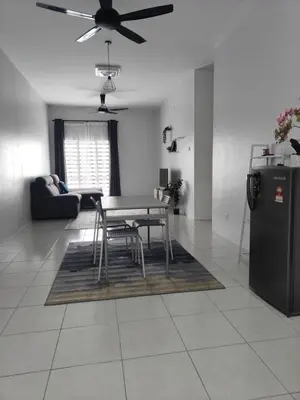 a living room with a table and a refrigerator at HS Homestay Casa Klebang Ipoh in Chemor