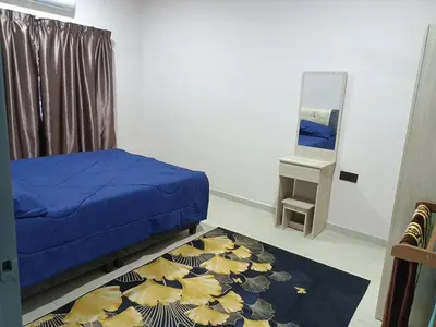 a bedroom with a blue bed and a mirror at QAUSAR HOMESTAY KERLING Hulu Selangor in Kerling