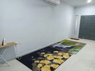 a hallway with a rug on the floor in a room at QAUSAR HOMESTAY KERLING Hulu Selangor in Kerling