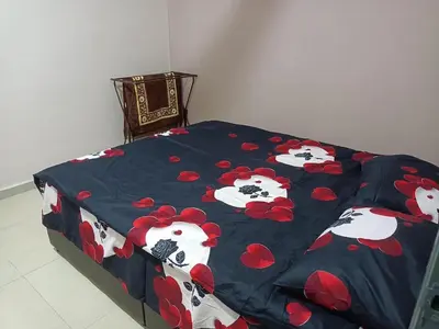 a bed with a blanket with cows on it at QAUSAR HOMESTAY KERLING Hulu Selangor in Kerling