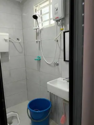 a bathroom with a shower and a toilet and a sink at QAUSAR HOMESTAY KERLING Hulu Selangor in Kerling