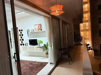 a hallway with a door open to a living room at Azure Haven - Seaview Resort Home, By the Sea Batu Ferringhi in Batu Ferringhi