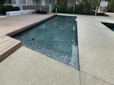 a swimming pool in the middle of a house at Azure Haven - Seaview Resort Home, By the Sea Batu Ferringhi in Batu Ferringhi