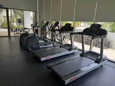 a row of treadmills in a gym at Azure Haven - Seaview Resort Home, By the Sea Batu Ferringhi in Batu Ferringhi