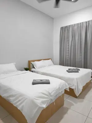 two beds sitting next to each other in a room at Cozy Haven \u6696\u5fc3\u5c45 in Simpang Ampat