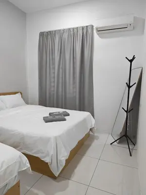 a white bedroom with a bed and a window at Cozy Haven \u6696\u5fc3\u5c45 in Simpang Ampat