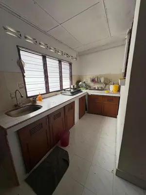 a small kitchen with a sink and a window at YDK Homestay in Padang Rengas
