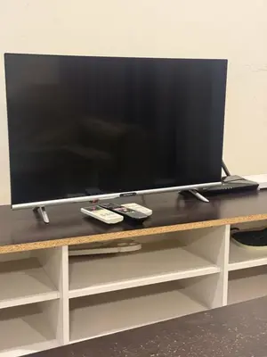 a flat screen tv sitting on top of a table at Studio Unit Trefoil Setia Alam in Gua Sai