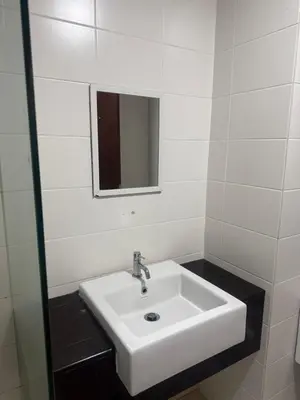 a bathroom with a white sink and a mirror at Studio Unit Trefoil Setia Alam in Gua Sai