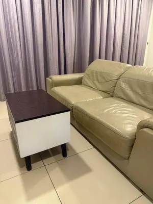 a living room with a couch and a coffee table at Studio Unit Trefoil Setia Alam in Gua Sai