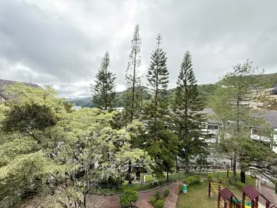 a view of a park with trees and a building at Equatorial Hill Resort, Mountain view In Cameron Highlands in Brinchang