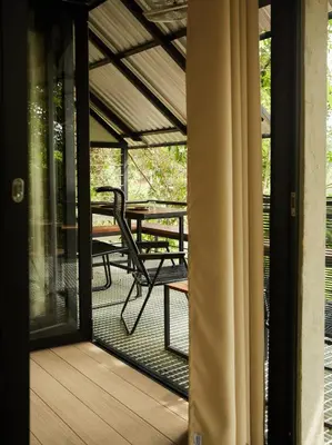 a screened porch with a table and a bench at Amazing Mountain View Lodge with Pool in Kuala Kubu Baharu
