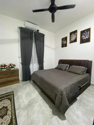 a bedroom with a bed and a ceiling fan at D'Savanna Homestay Gerik in Gua Sai