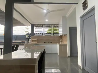 a kitchen with a table and a large window at D'Savanna Homestay Gerik in Gua Sai