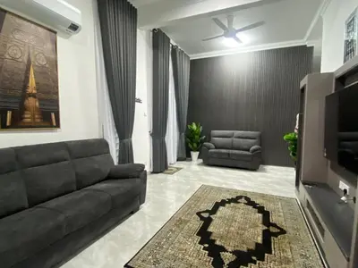 a living room with a couch and a tv at D'Savanna Homestay Gerik in Gua Sai
