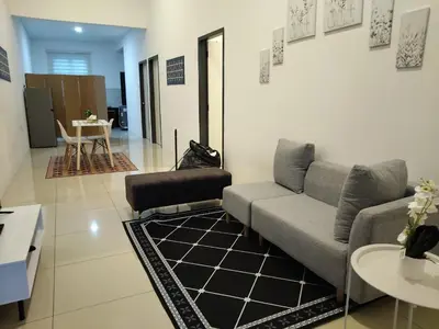 a living room with a couch and a table at D' Ara SZ Homestay in Kubang Semang