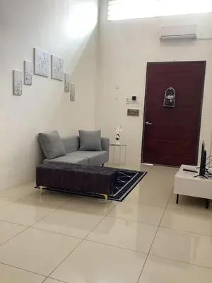 a living room with a couch and a red door at D' Ara SZ Homestay in Kubang Semang