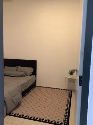 a bedroom with a bed with a black and white rug at D' Ara SZ Homestay in Kubang Semang