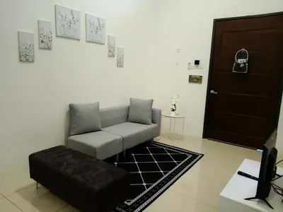 a living room with a couch and a chair at D' Ara SZ Homestay in Kubang Semang
