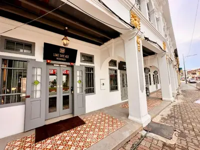 a building with a sign on the front of it at Loke Thye Kee Heritage Suite Hotel's in Gua Sai